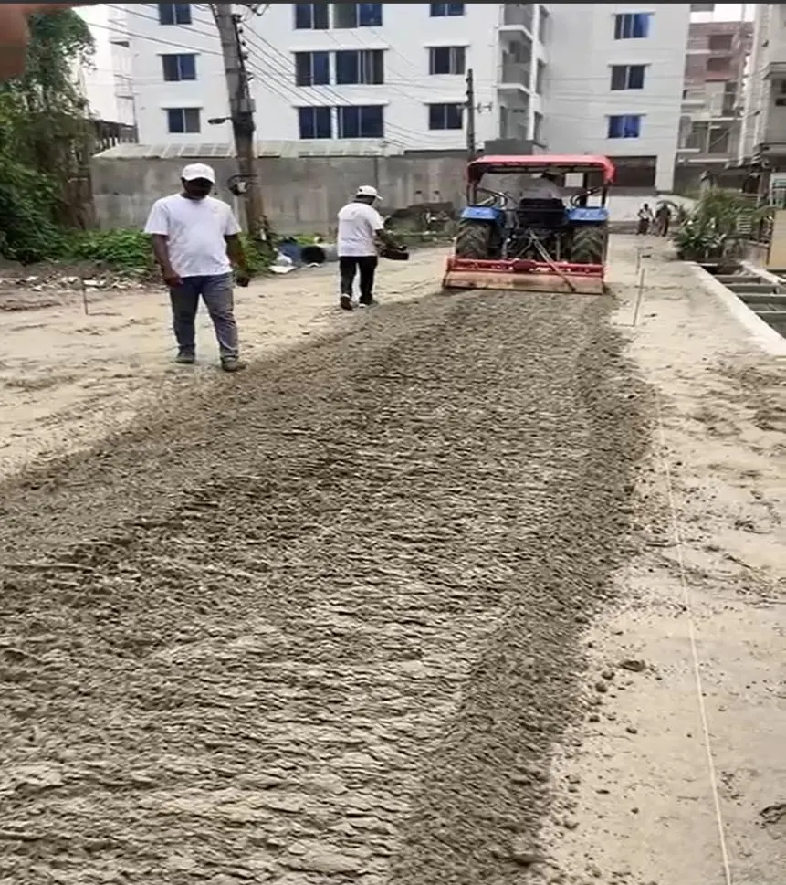 Day 1 — spreading cement and SoilBinder across the full width.
