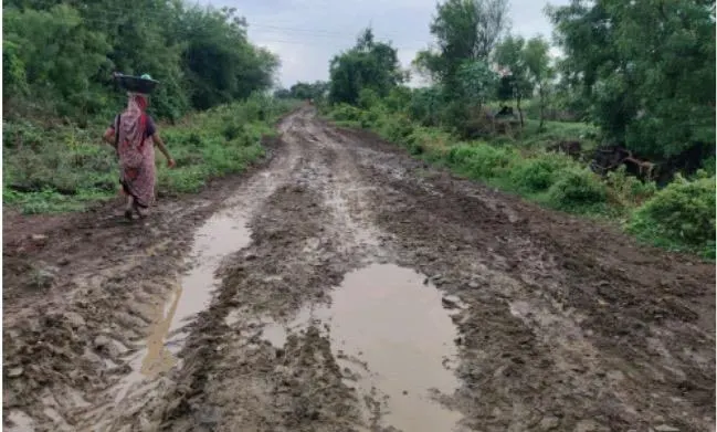 A rural Indian road churned into deep mud during the rainy season, before stabilization.